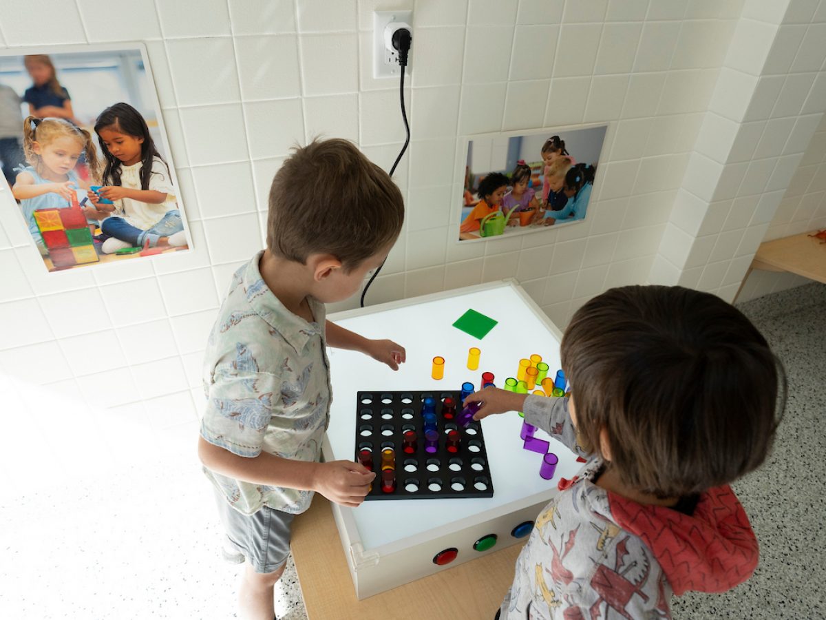 Children playing with blocks and other education toys in a classroom